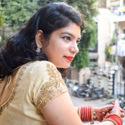 Beautiful woman dressed up as indian tradition with henna mehndi design on her both hands