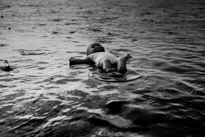 Young woman swimming in sea