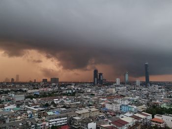 Aerial view of buildings against sky during sunset