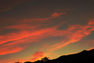 Low angle view of dramatic sky during sunset