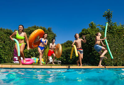 Rear view of woman swimming in pool