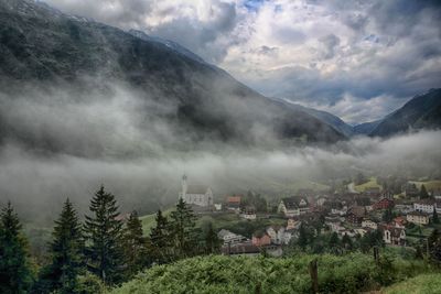 Scenic view of mountains against cloudy sky