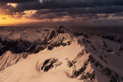 Scenic view of snowcapped mountains against sky during sunset