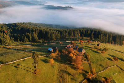 Aerial view of houses on landscape against sky