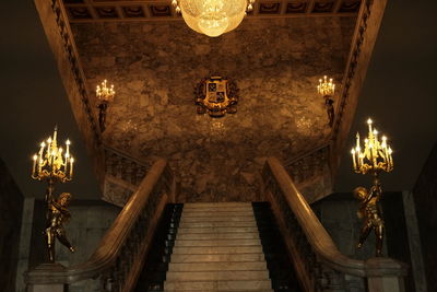 Low angle view of illuminated chandelier in building