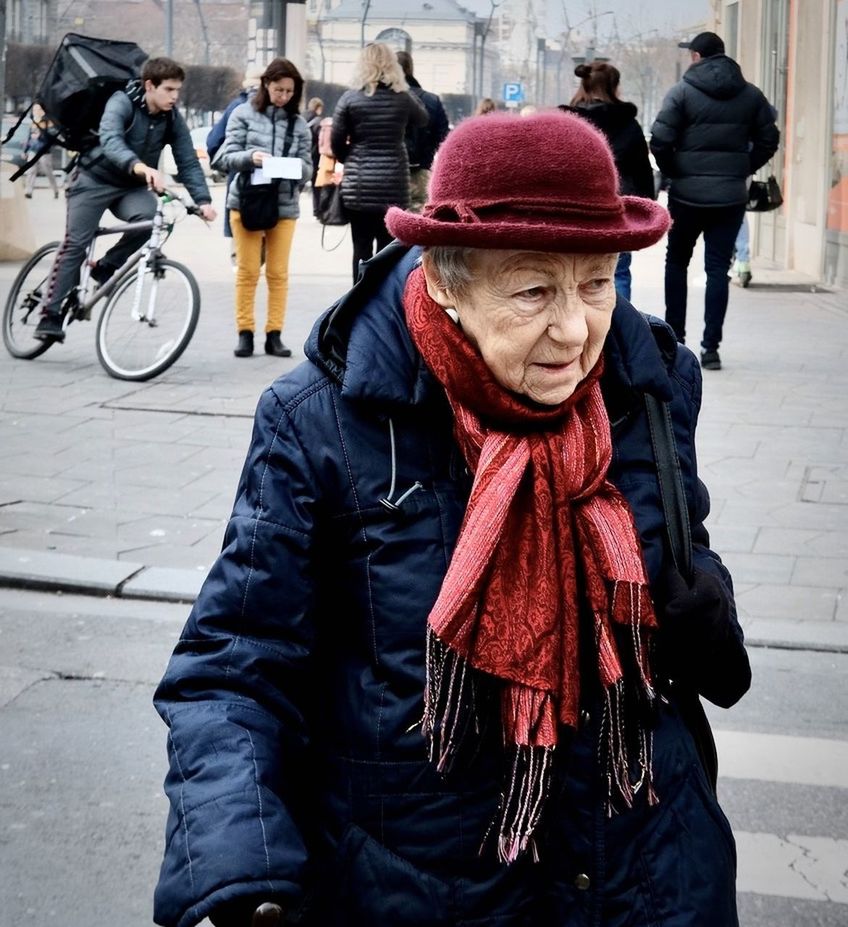 MAN WITH BICYCLE ON STREET IN WINTER