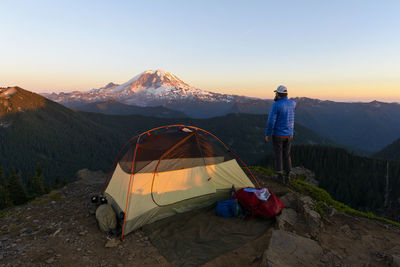 Portrait of hiker with tent backpacking