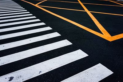 Close-up of zebra crossing on road