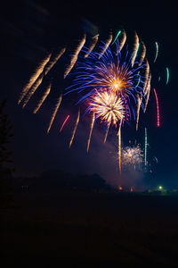 Low angle view of firework display at night