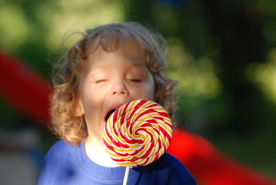 Close-up of cute boy eating lollipop