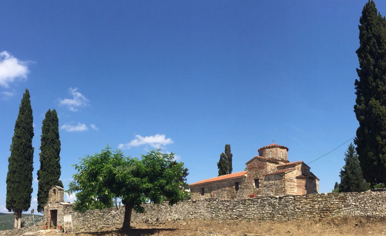 architecture, built structure, history, building exterior, old ruin, ancient, blue, the past, low angle view, sky, clear sky, tree, religion, ancient civilization, place of worship, old, famous place, spirituality, sunlight, copy space