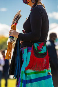 Rear view of woman holding multi colored umbrella