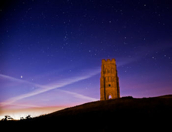 Low angle view of castle against sky at night