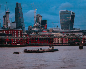 Buildings at waterfront during dusk