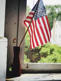 Close-up of flags hanging against built structure