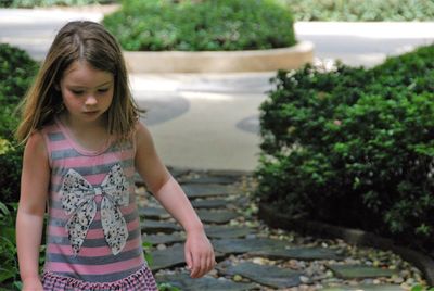 Girl on tree by water