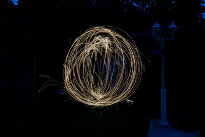 Low angle view of illuminated lights at night