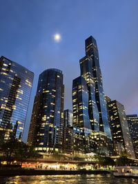 Low angle view of illuminated buildings in city at night