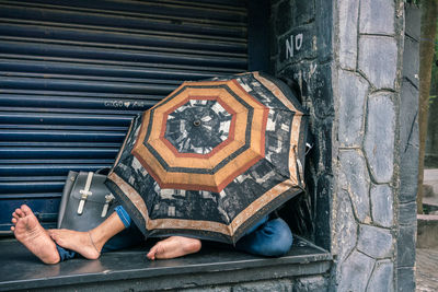 Low section of man sitting on metal structure