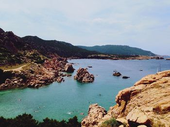 Scenic view of sea and mountains against sky