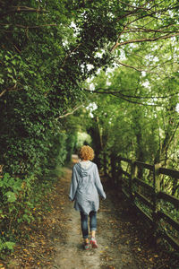 Rear view of man walking on road