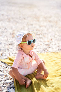 Portrait of young woman wearing sunglasses on beach