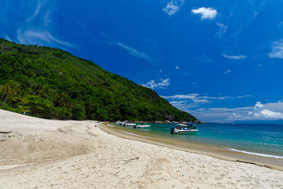 Scenic view of beach against blue sky