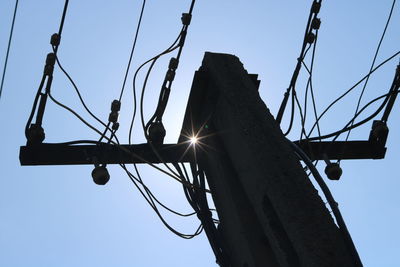 Low angle view of electricity pylon against sky