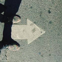 Low section of person standing on road