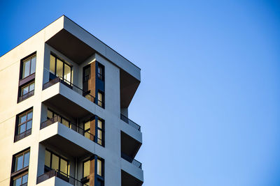 Low angle view of building against clear blue sky