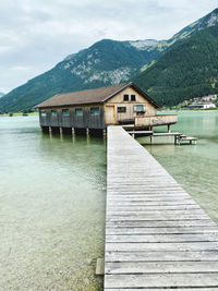 Pier over lake against sky