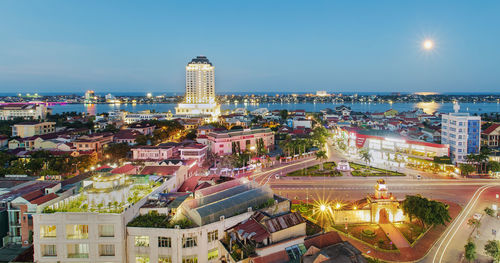 High angle view of illuminated city buildings against sky