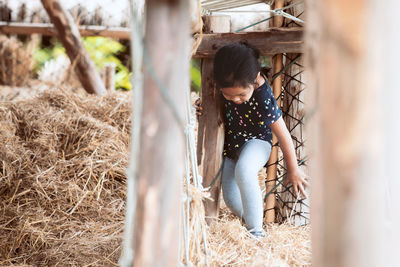 Portrait of girl playing on hay 