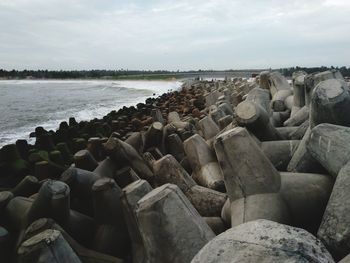 Stack of stones on beach against sky