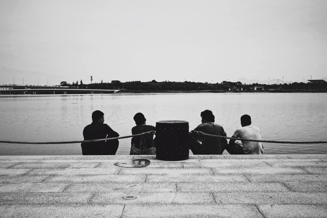 water, men, real people, sitting, sea, leisure activity, outdoors, clear sky, sky, lifestyles, medium group of people, day, women, nature, nautical vessel, friendship, adult, people