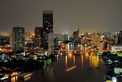 High angle shot of river along illuminated city