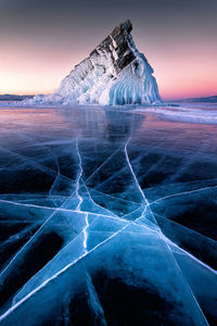 Frozen sea against sky during winter