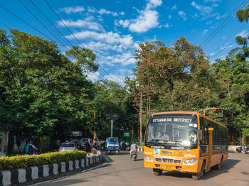 Cars on street in city against sky