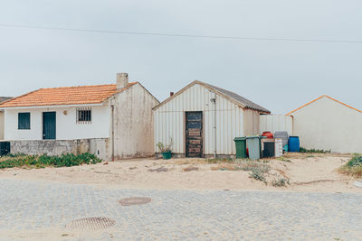 Beach huts against clear sky