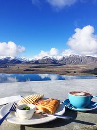 Breakfast on wall against sky