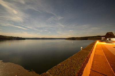 Scenic view of lake against sky at sunset