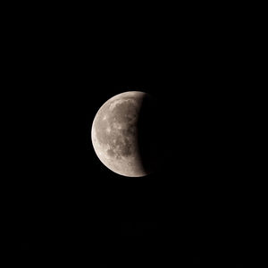 Low angle view of half moon against sky at night