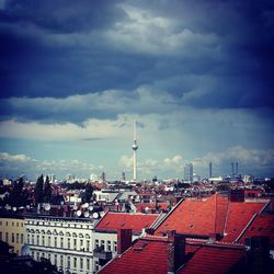 Cityscape against cloudy sky