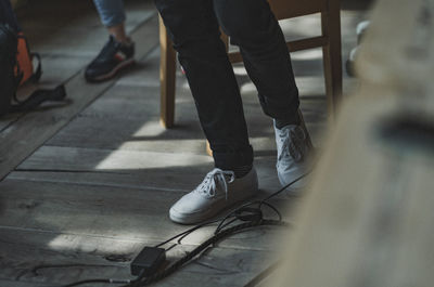 Low section of people walking on floor