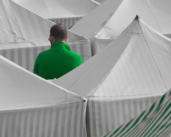 Rear view of man looking at camera