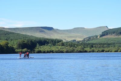 Scenic view of lake against clear blue sky