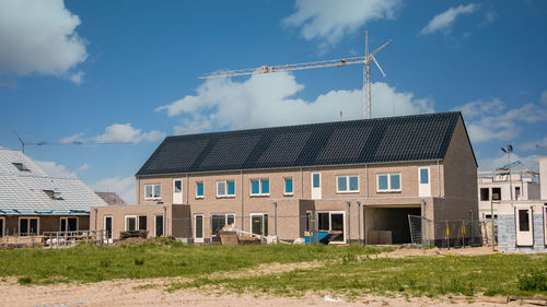 Built structures on field against sky