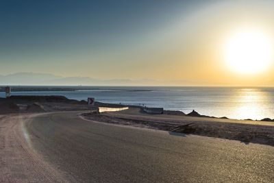 Scenic view of beach against sky during sunset