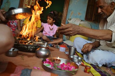 People sitting by fire at home