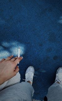 Low section of woman smoking cigarette